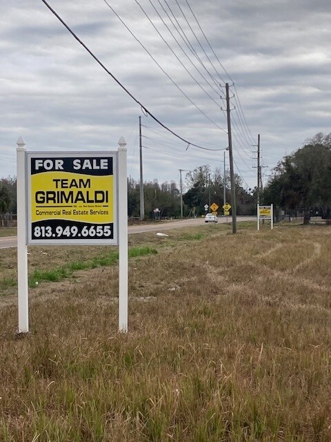 Corner Lot For Sale in Odessa A 'For Sale' sign on the 4.7-acre commercial corner lot at Gunn Highway and Wayne Rd in Odessa, FL.