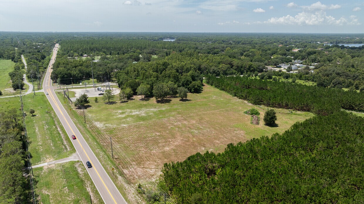 Angled Aerial View of Odessa Land An angled aerial photograph looking down Wayne Road, with the expansive 4.7-acre commercial lot visible on the right.