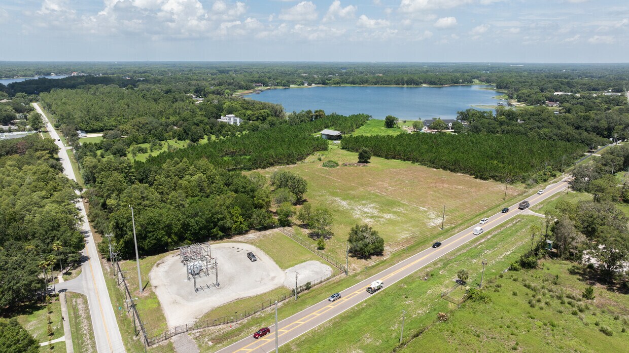 High Angle View of Commercial Lot A high-angle aerial shot capturing the full scope of the cleared 4.7-acre lot with traffic visible on Wayne Rd.
