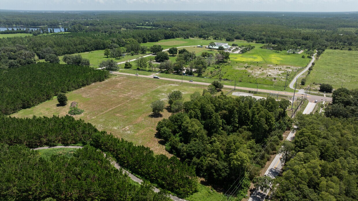 Corner Lot Viewed from the East An aerial shot from the east, looking west over the property, showing the corner of Gunn Hwy and Wayne Rd and the adjacent power substation.