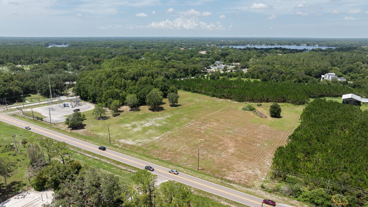Commercial Corner Lot on Gunn Hwy Aerial perspective showing traffic on Wayne Rd and the property's prime corner location at the intersection with Gunn Highway.