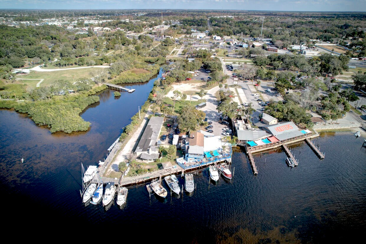 A comprehensive aerial view of the waterfront restaurant and the extensive commercial marina with numerous boat slips, highlighting the scale of this investment opportunity.