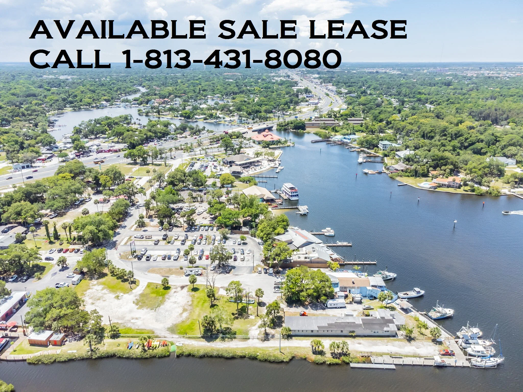 Aerial view of the property with contact information for sale or lease inquiries regarding this prime waterfront restaurant and marina development opportunity.