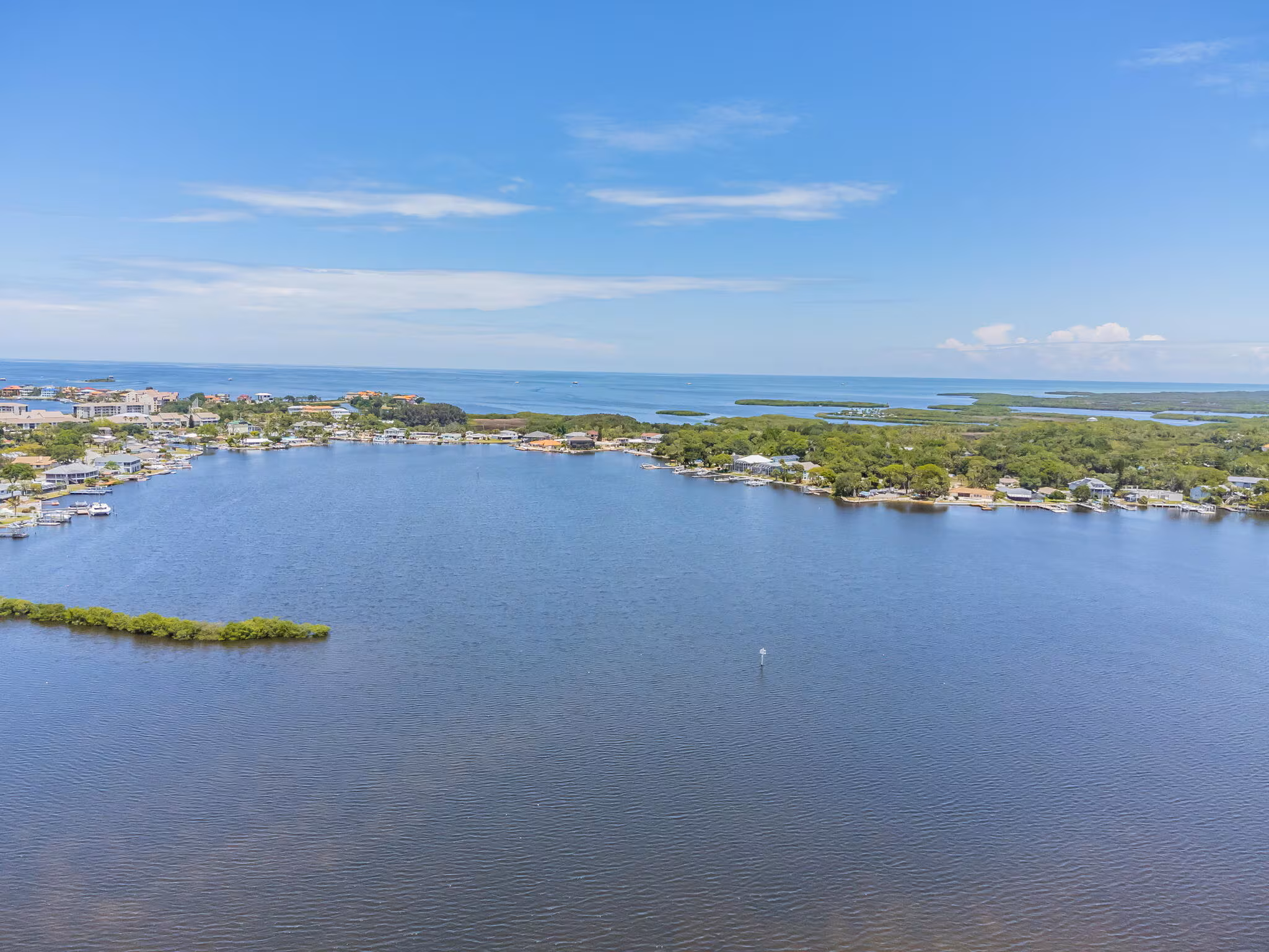 A stunning aerial view showing the harbor and its direct, unobstructed access to the open waters of the Gulf of Mexico, a prime feature of this investment opportunity.